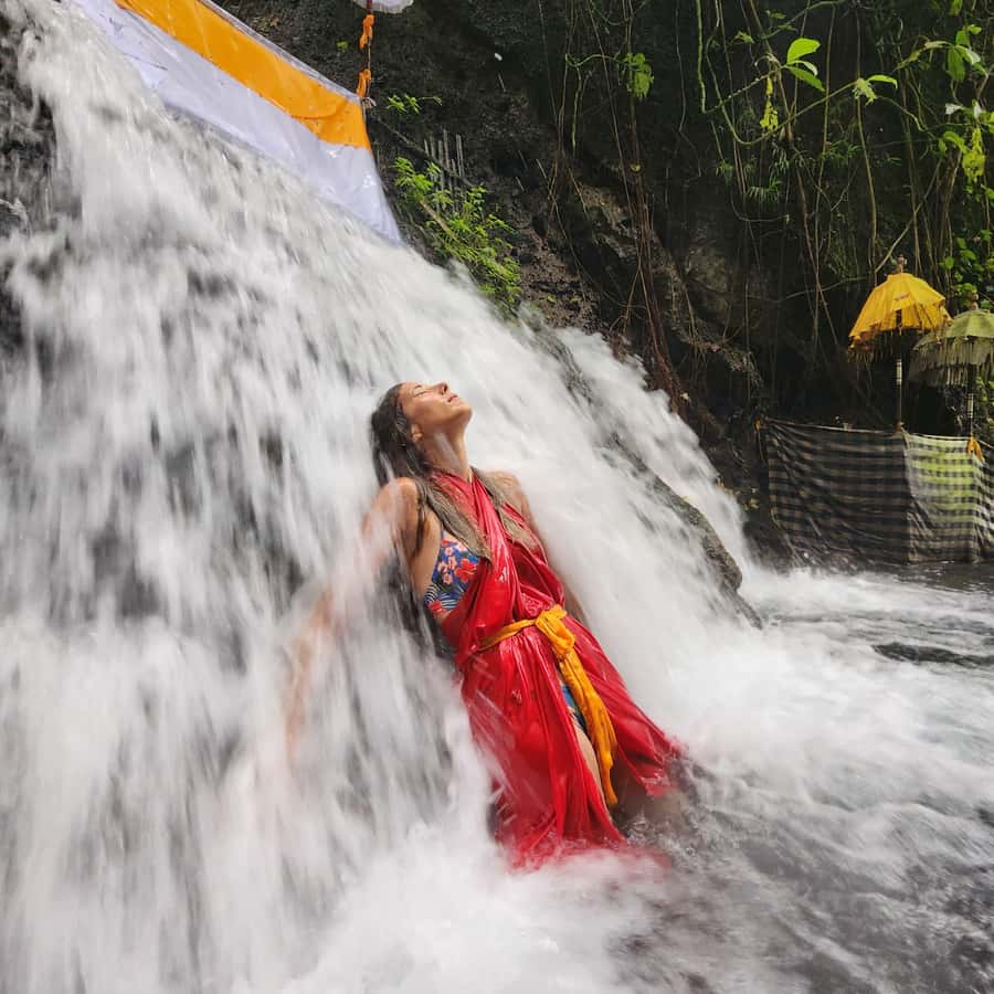 Balinese Purification at holy water temple with Local - Entering the holy water with local guidance