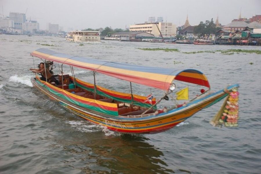 Bangkok: Private Thonburi Longtail Boat Tour & Wat Pho Visit - A traditional longtail boat with a practical tradeoff