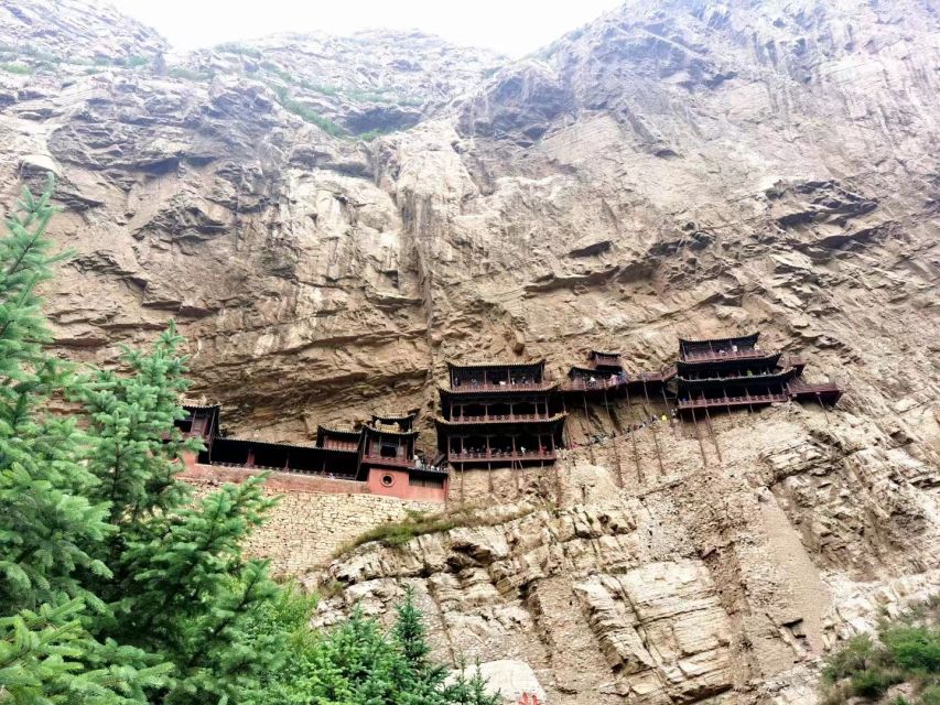 Datong: Temples and Grottoes day tour with tickets options - Looking up at the Hanging Monastery