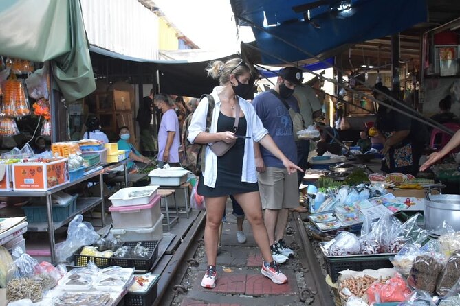 Floating Market with Great Pagoda Temple and Wat Sam Phran - Maeklong Railway Market, where commerce hugs the tracks