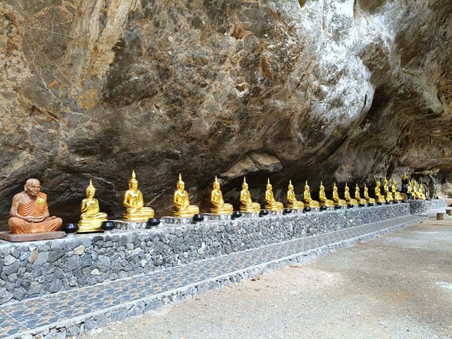 Khao Sok: Private Bamboo Rafting & Jungle Cave Temple Tour - Feeding fish from a handmade raft